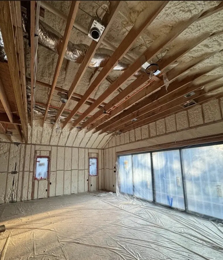 Interior walls and ceiling insulated with spray foam during new construction in Waupun